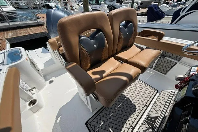 Slide: The Image of 2021 Wellcraft 242 Fisherman boat with tan leather seats at a marina. - 15