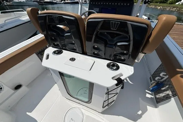 Slide: The Image of 2021 Wellcraft 242 Fisherman boat interior with dual seats and fishing equipment. - 19