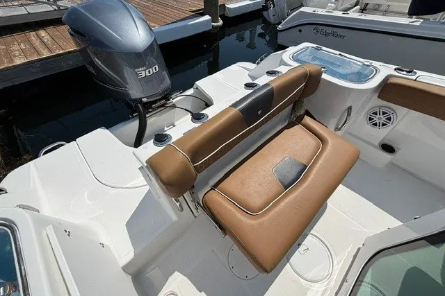 Slide: The Image of 2021 Wellcraft 242 Fisherman boat interior with brown seating and powerful 300 HP engine. - 21