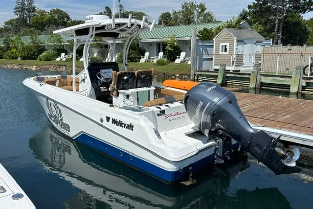Slide: The Image of 2021 Wellcraft 242 Fisherman boat docked, featuring Yamaha outboard motor. - 3