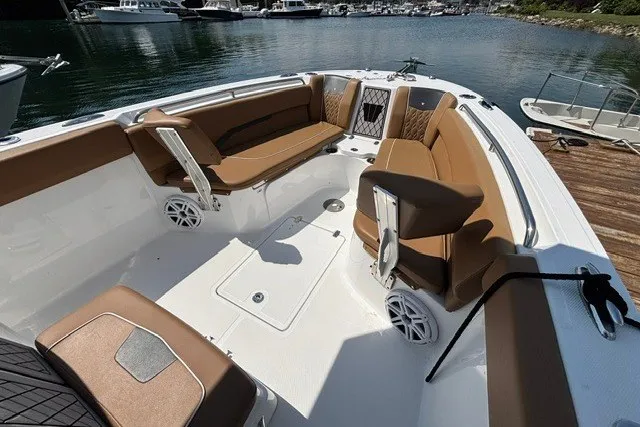 Slide: The Image of 2021 Wellcraft 242 Fisherman boat interior with brown seating, docked at a marina. - 9