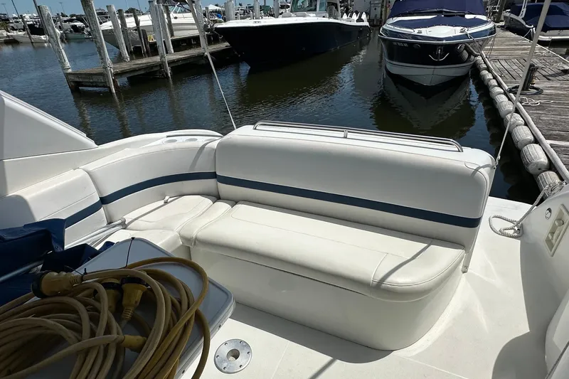 Slide: The Image of 1999 Formula 400 Super Sport boat interior with white seating at marina. - 5
