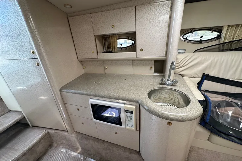 Slide: The Image of Interior of 1999 Formula 400 Super Sport yacht with kitchenette and modern amenities. - 11