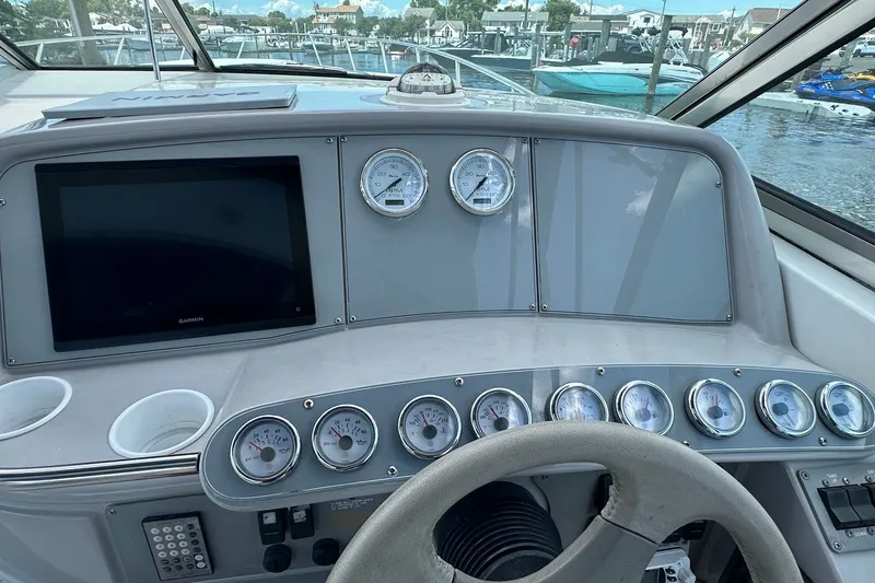 Slide: The Image of 1999 Formula 400 Super Sport dashboard with gauges and Garmin display at marina. - 9
