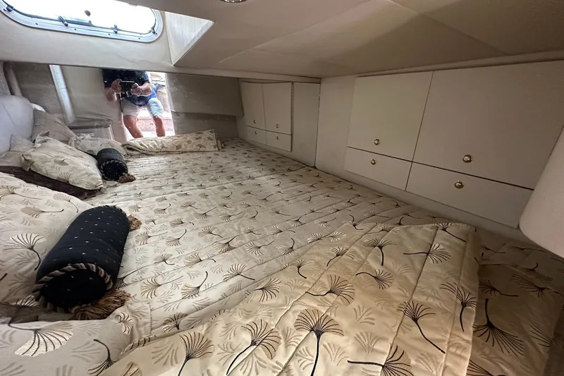 Slide: The Image of Interior cabin of a 1999 Formula 400 Super Sport boat with elegant bedding and storage. - 13