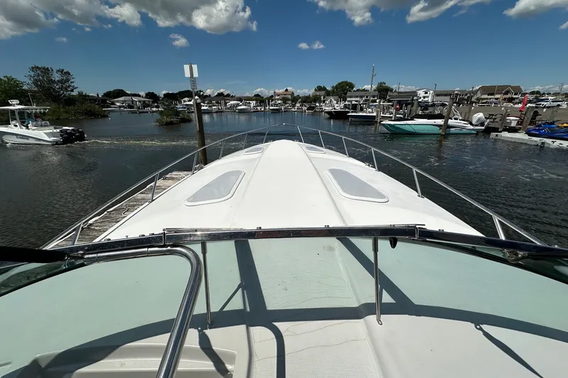 Slide: The Image of 1999 Formula 400 Super Sport boat docked in a marina under a clear blue sky. - 3