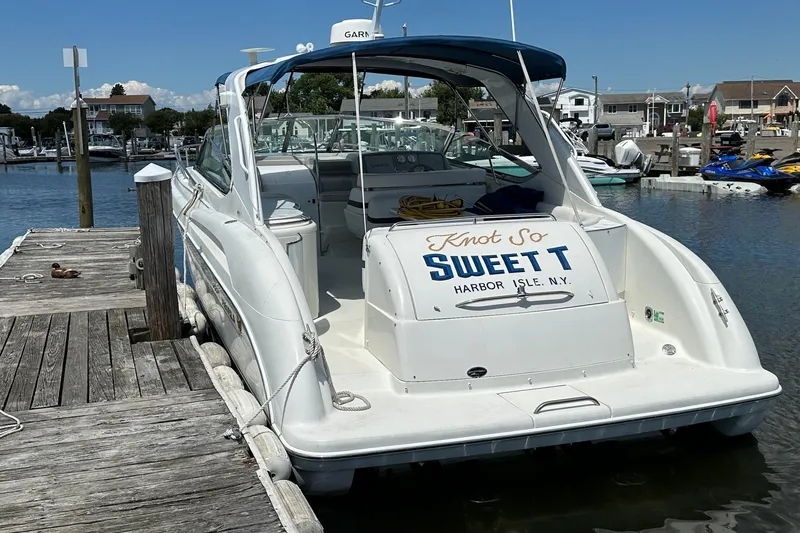Slide: The Image of 1999 Formula 400 Super Sport boat docked at Harbor Isle, New York marina. - 2