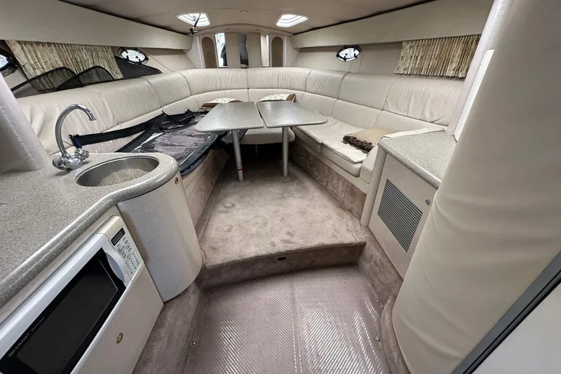 Slide: The Image of Interior of a 1999 Formula 400 Super Sport boat with seating and kitchenette. - 10