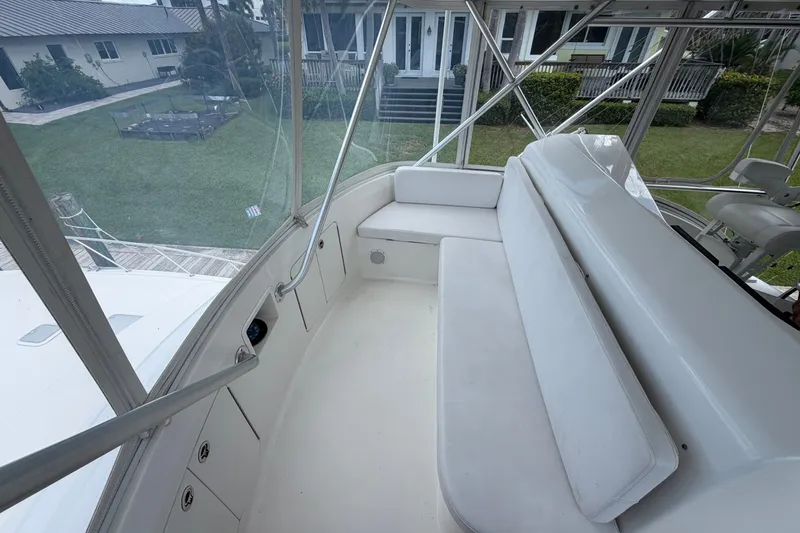 Slide: The Image of 2007 Post 50 Convertible yacht interior with white seating and outdoor view. - 34