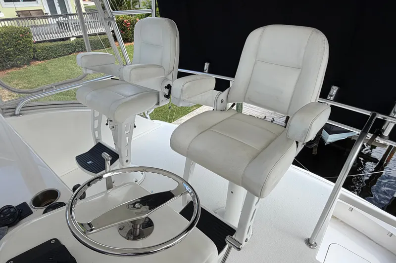Slide: The Image of White captain chairs on a 2007 Post 50 Convertible yacht deck. - 21