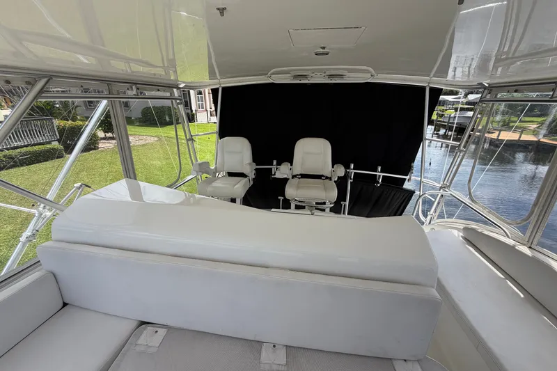 Slide: The Image of 2007 Post 50 Convertible yacht interior with white seating and helm chairs. - 35