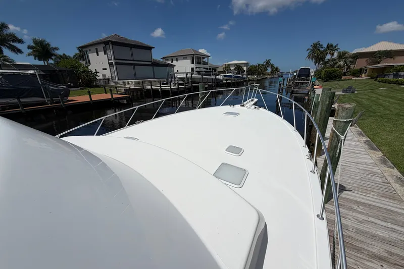 Slide: The Image of 2007 Post 50 Convertible yacht docked in a scenic residential canal. - 6