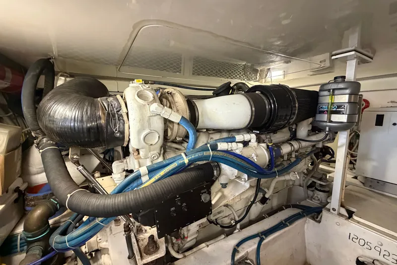 Slide: The Image of Engine room of a 2007 Post 50 Convertible yacht, showcasing detailed machinery and components. - 100