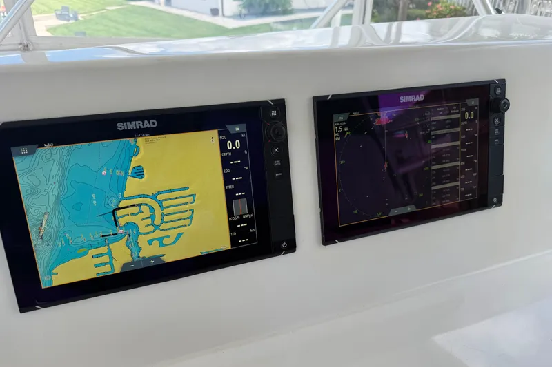 Slide: The Image of Simrad navigation displays on a 2007 Post 50 Convertible boat dashboard. - 25
