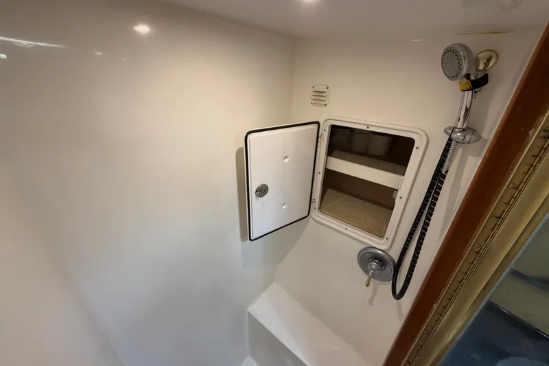 Slide: The Image of Shower area in 2007 Post 50 Convertible yacht with storage compartment and handheld showerhead. - 85