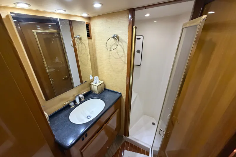 Slide: The Image of Luxurious bathroom in a 2007 Post 50 Convertible yacht, featuring a sleek sink and shower. - 89