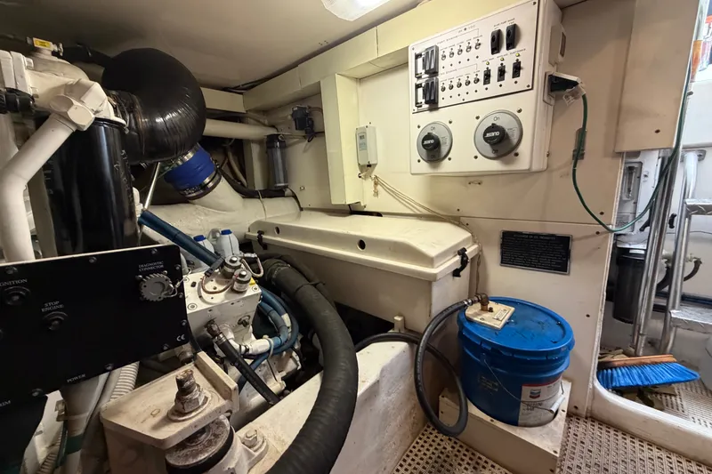 Slide: The Image of Engine room of a 2007 Post 50 Convertible yacht, featuring control panels and equipment. - 107