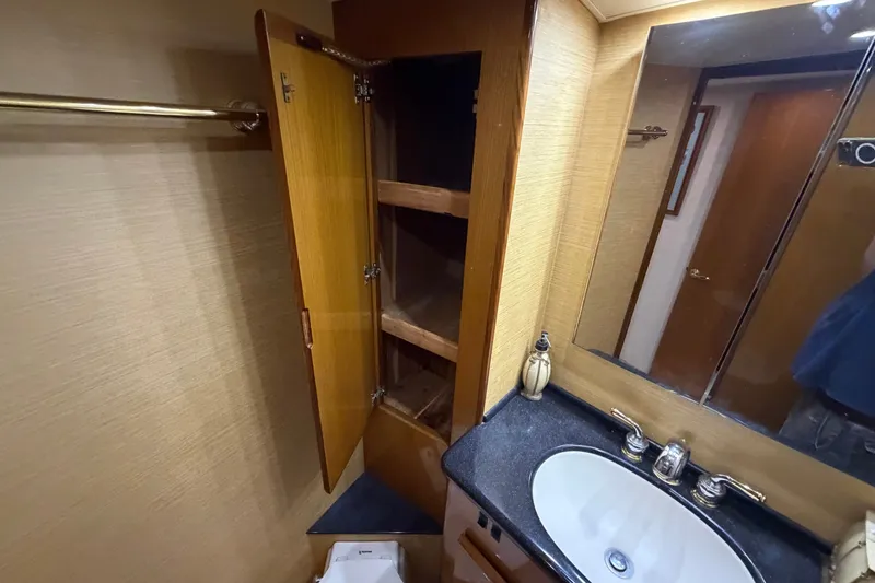 Slide: The Image of Bathroom vanity with open wooden cabinet in 2007 Post 50 Convertible yacht. - 91