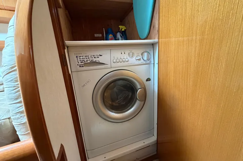 Slide: The Image of Laundry area with a washing machine inside a 2007 Post 50 Convertible boat. - 96