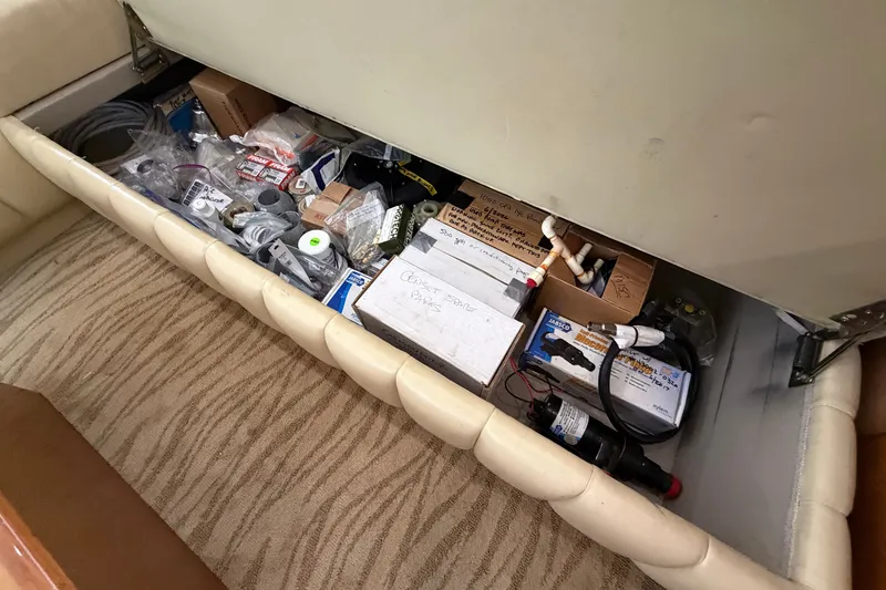 Slide: The Image of Storage compartment in a 2007 Post 50 Convertible, filled with various tools and spare parts. - 53