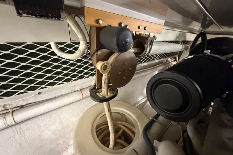 Slide: The Image of Engine compartment of a 2007 Post 50 Convertible boat, showcasing mechanical components and wiring. - 113