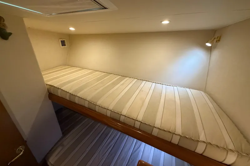 Slide: The Image of Bunk beds in 2007 Post 50 Convertible yacht cabin with striped mattresses and recessed lighting. - 76