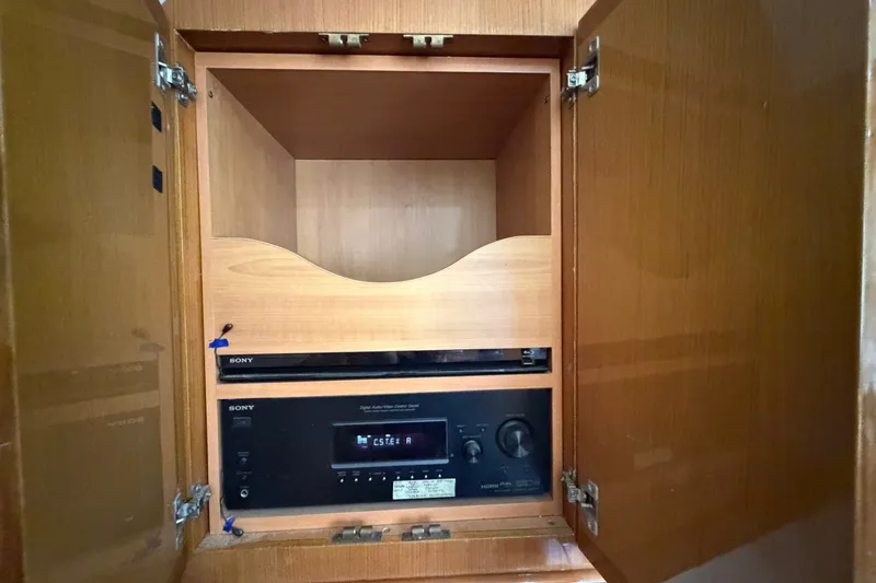 Slide: The Image of Wooden cabinet with Sony audio equipment, open doors, in a 2007 Post 50 Convertible. - 71
