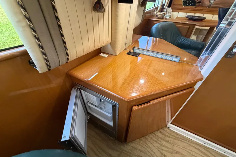Slide: The Image of Interior of 2007 Post 50 Convertible yacht with wooden cabinetry and open mini fridge. - 47