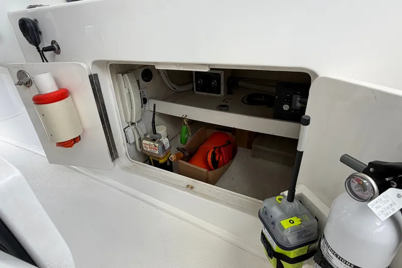 Slide: The Image of Storage compartment on a 2007 Post 50 Convertible boat with safety equipment and electronics. - 31