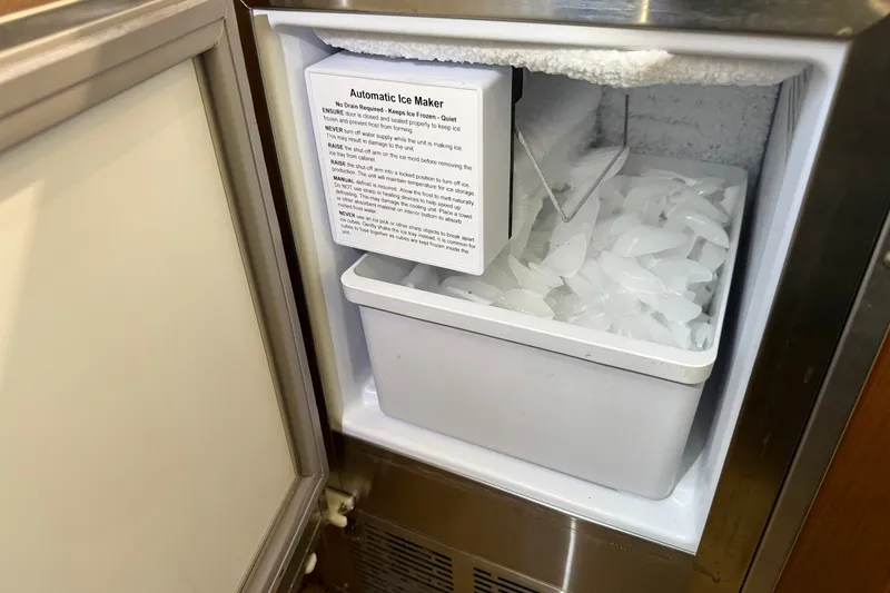 Slide: The Image of Automatic ice maker in a 2007 Post 50 Convertible, filled with ice cubes. - 48