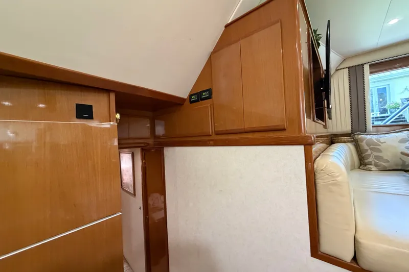 Slide: The Image of Interior of 2007 Post 50 Convertible yacht with wooden cabinetry and white seating area. - 64