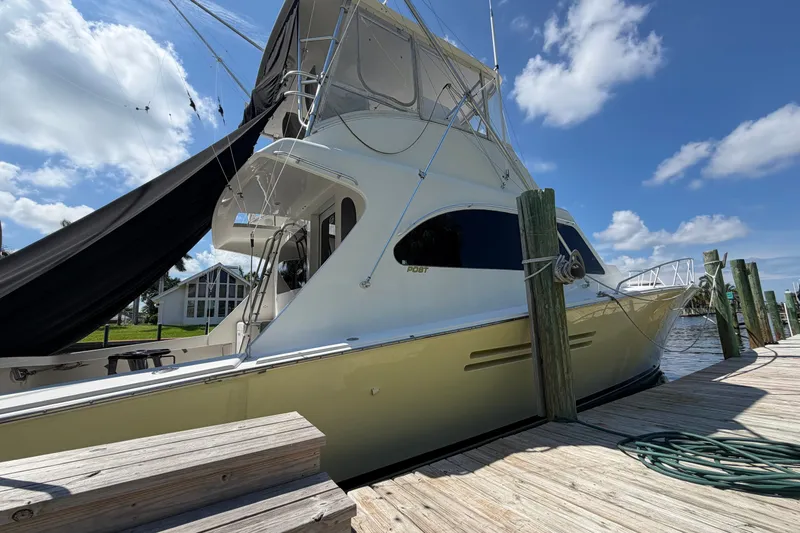 Slide: The Image of Luxury 2007 Post 50 Convertible yacht docked under a clear blue sky. - 4