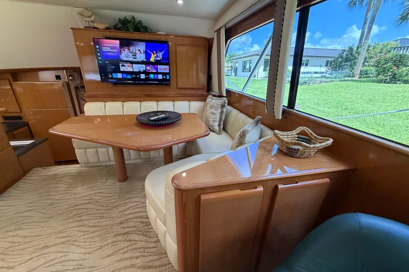 Slide: The Image of Luxurious interior of a 2007 Post 50 Convertible yacht with dining area and TV. - 51