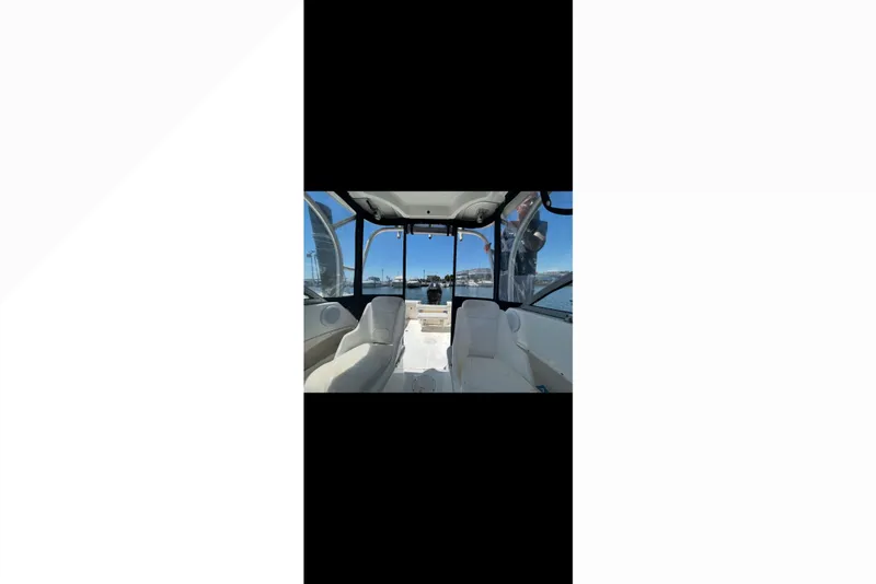 Slide: The Image of Interior view of 2005 Boston Whaler 235 Conquest boat with seating and windows. - 21