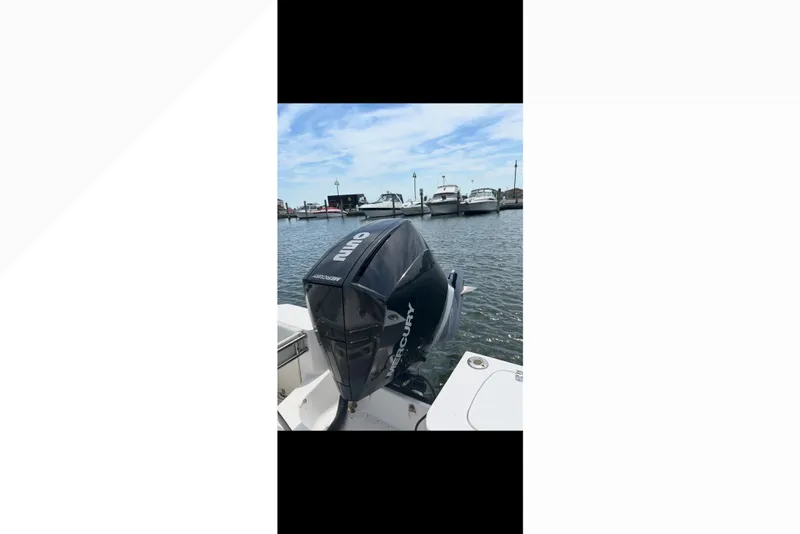 Slide: The Image of Boston Whaler 235 Conquest 2005 with Mercury outboard motor at marina. - 23