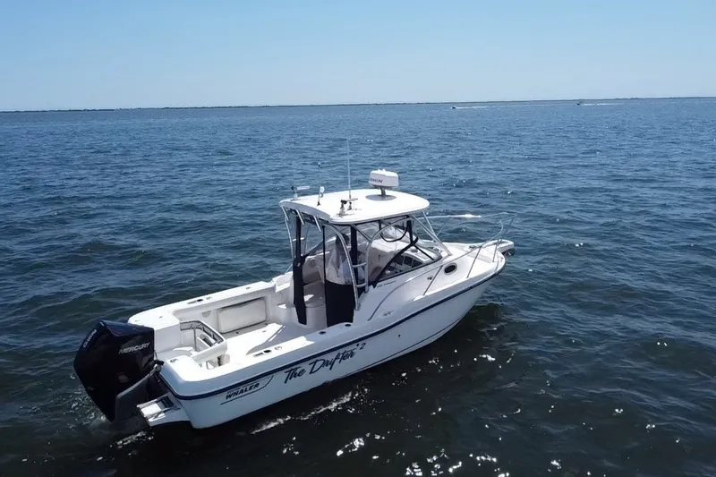 Slide: The Image of 2005 Boston Whaler 235 Conquest boat cruising on open water. - 3