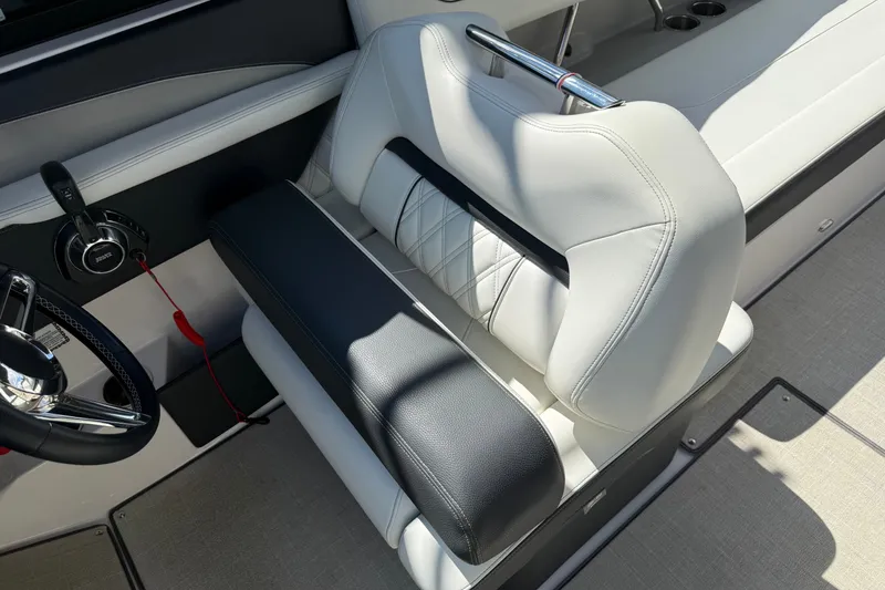 Slide: The Image of 2021 Regal LS6 boat interior with luxurious white and black seating and steering wheel. - 5
