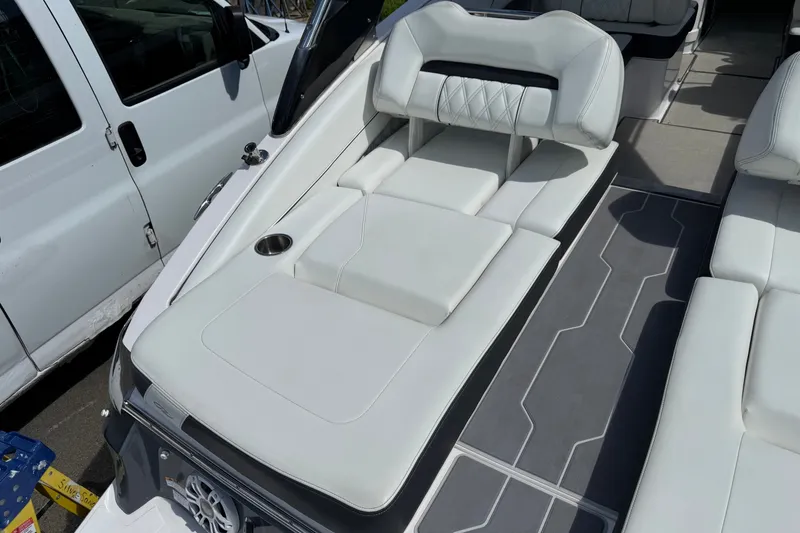 Slide: The Image of 2021 Regal LS6 boat interior with white seating and cup holder. - 9