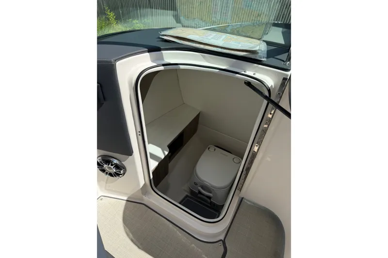Slide: The Image of 2021 Regal LS6 boat interior with compact toilet and storage area. - 8
