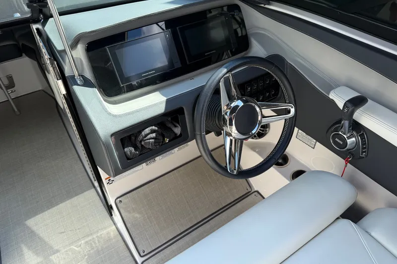 Slide: The Image of 2021 Regal LS6 boat dashboard with steering wheel and control panel. - 4