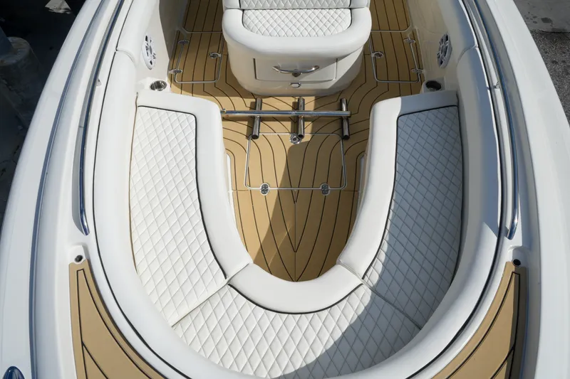 Slide: The Image of 2008 Chris-Craft Catalina 26 boat interior with white quilted seating and teak flooring. - 22