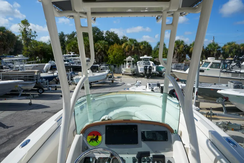 Slide: The Image of 2008 Chris-Craft Catalina 26 boat dashboard view in a marina with other boats. - 16
