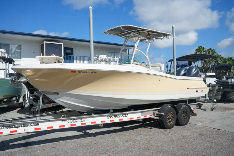 Slide: The Image of 2008 Chris-Craft Catalina 26 boat on trailer, parked outdoors under blue sky. - 3