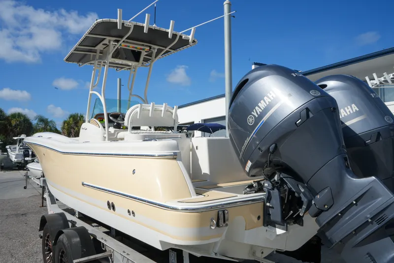 Slide: The Image of 2008 Chris-Craft Catalina 26 boat with Yamaha engines, parked outdoors under a clear blue sky. - 6