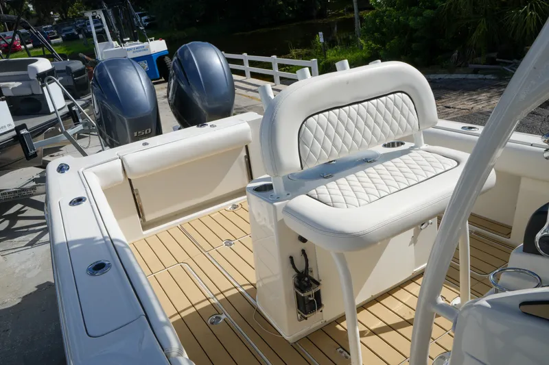 Slide: The Image of 2008 Chris-Craft Catalina 26 boat interior with white seating and dual outboard engines. - 28