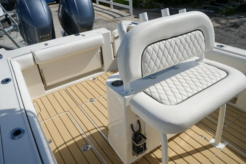 Slide: The Image of 2008 Chris-Craft Catalina 26 boat interior with white quilted seating and dual outboard engines. - 29