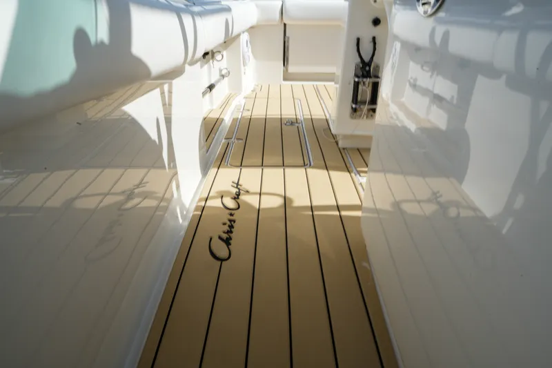 Slide: The Image of 2008 Chris-Craft Catalina 26 boat deck with teak flooring and logo. - 26