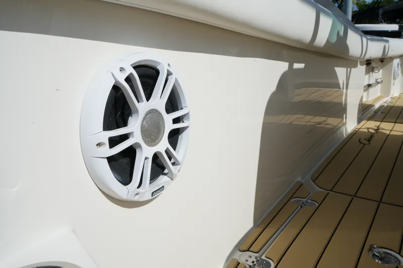 Slide: The Image of White speaker on 2008 Chris-Craft Catalina 26 boat deck, showcasing marine audio system. - 24