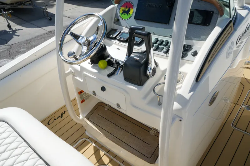 Slide: The Image of 2008 Chris-Craft Catalina 26 boat helm with steering wheel and controls. - 17