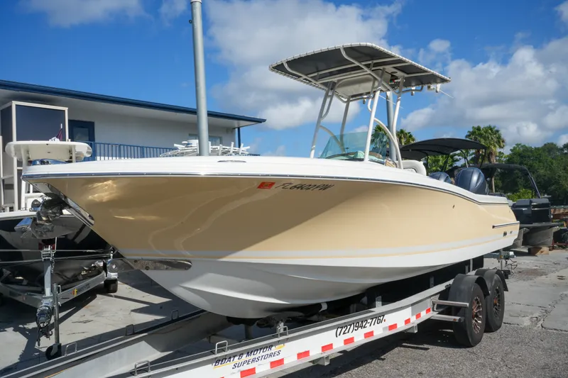 Slide: The Image of 2008 Chris-Craft Catalina 26 boat on trailer, parked outdoors under blue sky. - 4